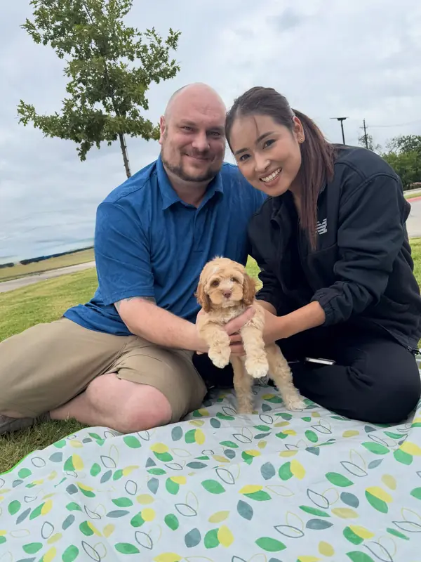 A family on gotcha day, taking home their Bernedoodle puppy from KK Doodles