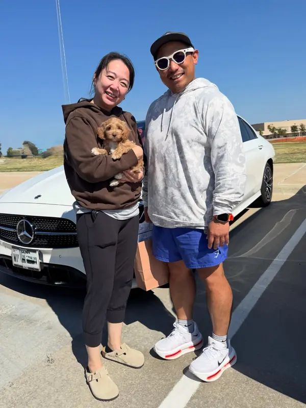 A family on gotcha day, taking home their Bernedoodle puppy from KK Doodles