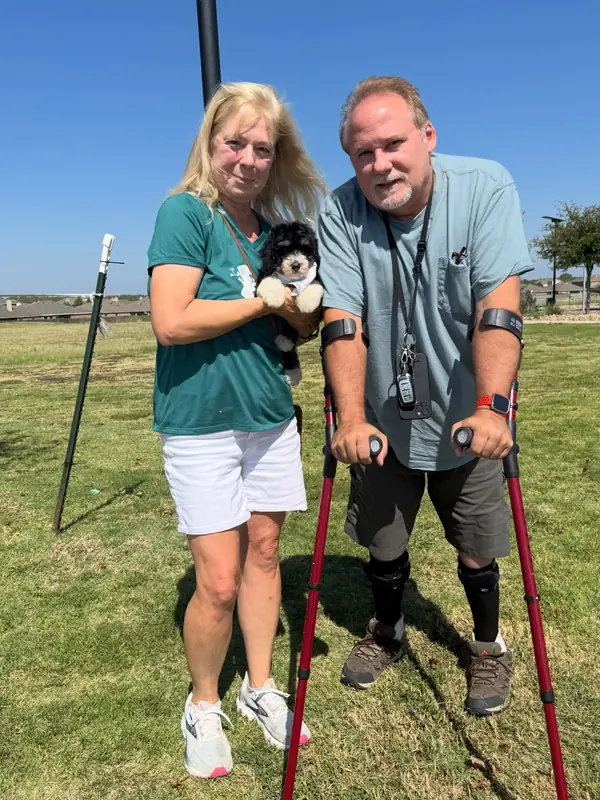 A family on gotcha day, taking home their Bernedoodle puppy from KK Doodles